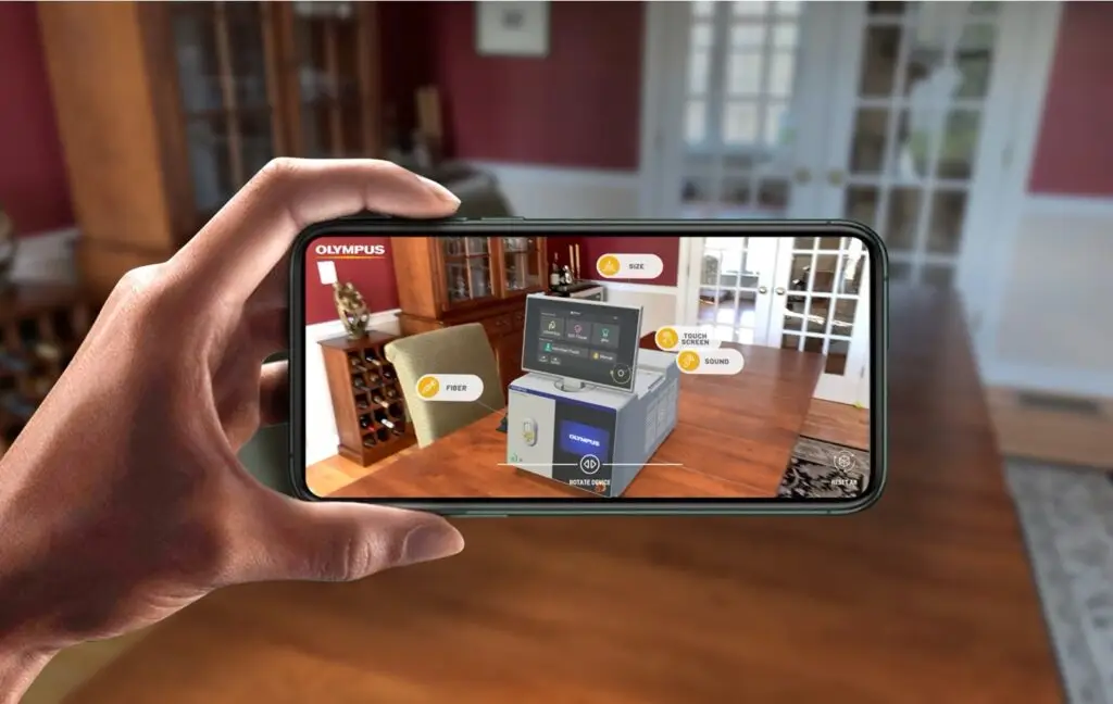 Image of a hand holding a mobile phone with the AR app, SOLTIVE, in use.